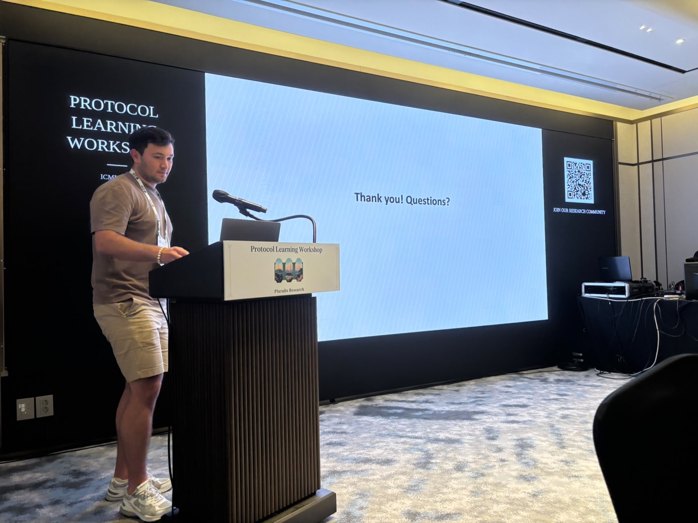 Speaker concluding a talk at the ICML Protocol Learning workshop