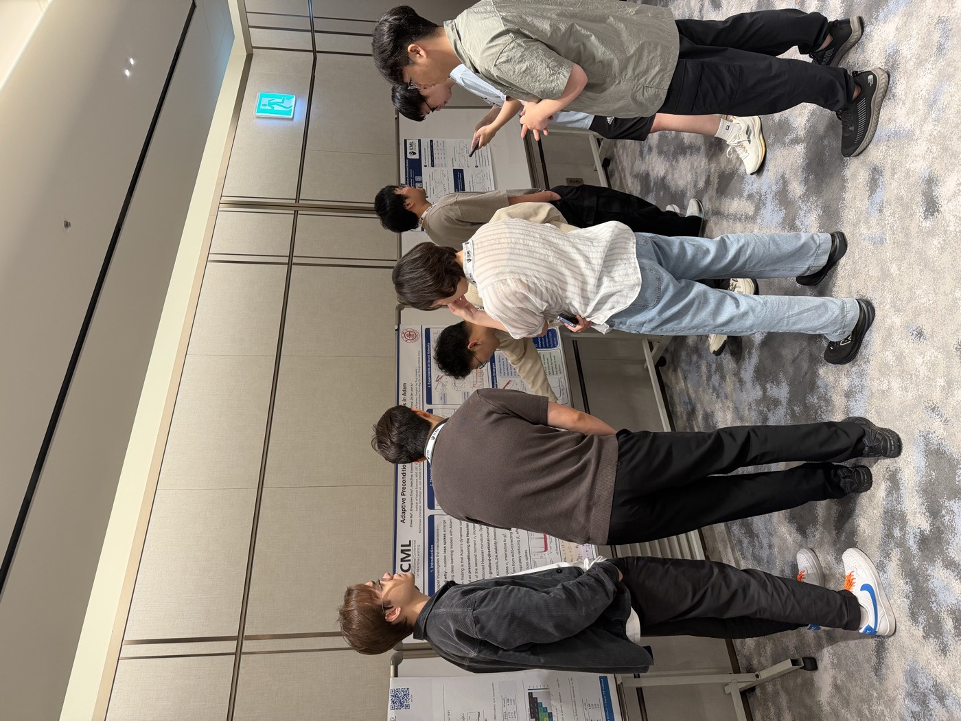 Researchers discussing a poster at the Protocol Learning workshop