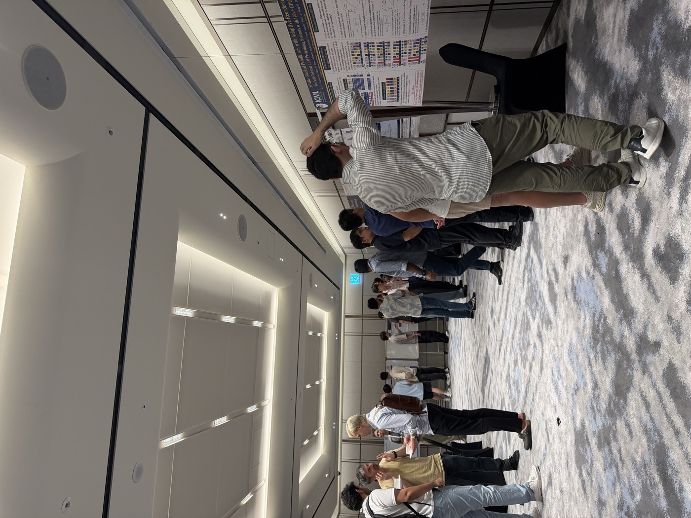 Workshop attendees gathered around the poster displays